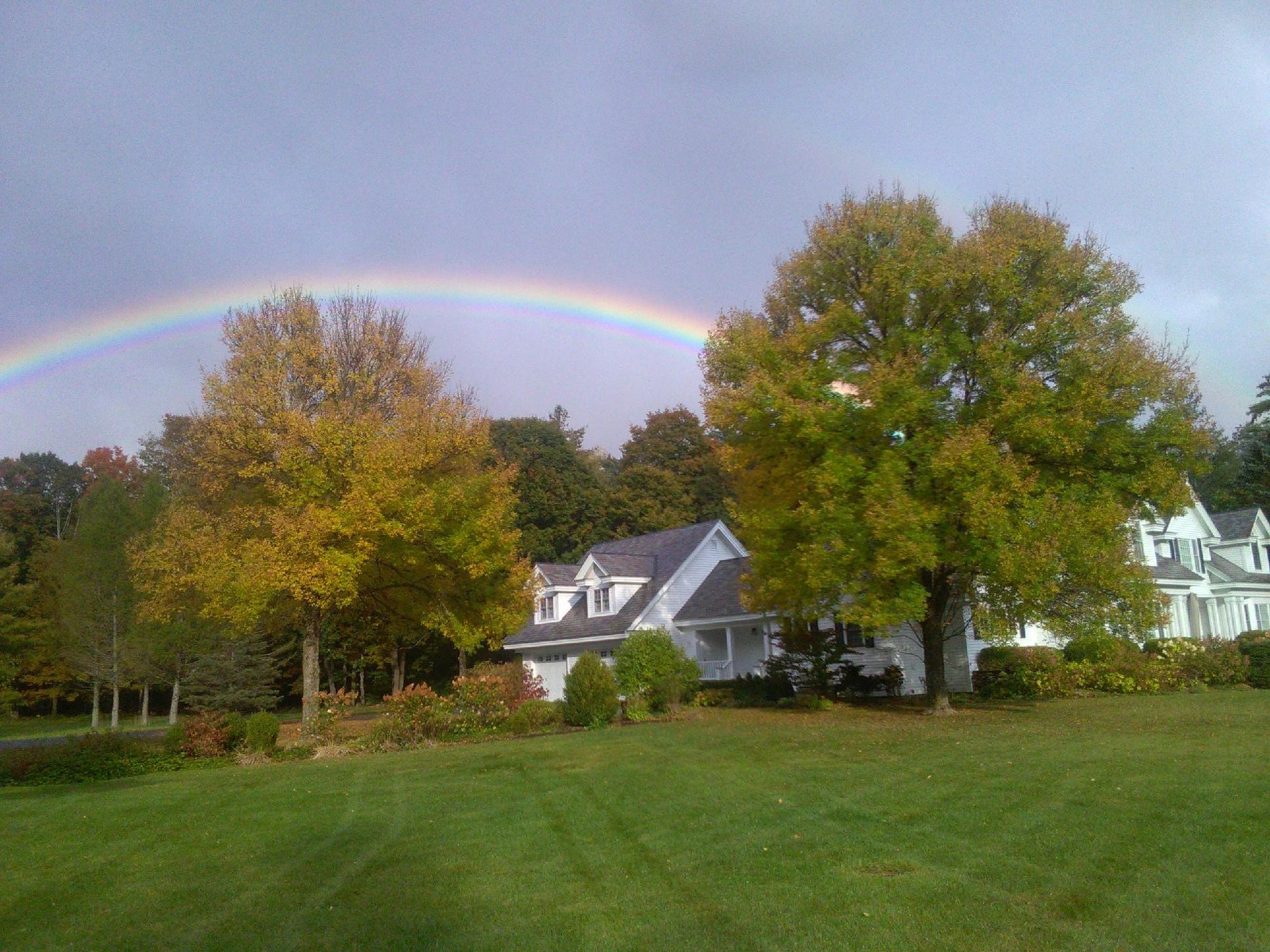 Picturesque rainbow over clients home and thriving green lawn